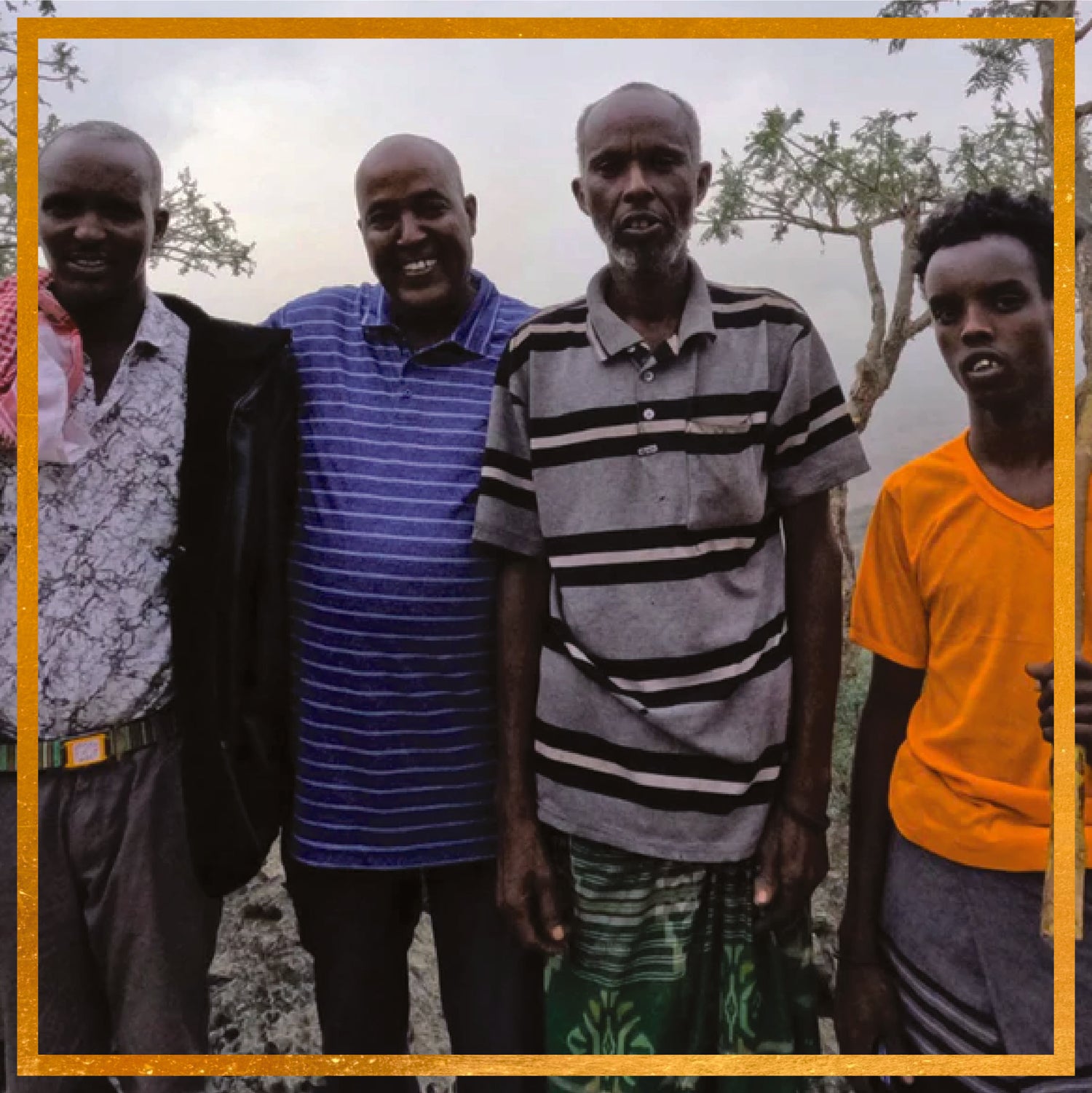 Mahdi standing with frankincense harvesters outdoors in the Sanaag region of Somaliland