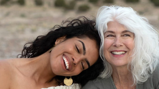 Two women smiling together in a warm portrait for virtual skincare consultations