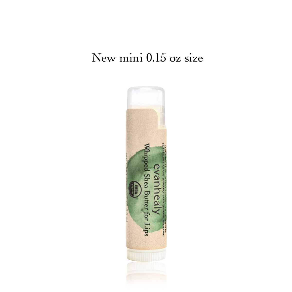 Front view of Whipped Shea Butter for Lips mini lip balm tube with green label, marked New mini 0.15 oz size, on white background