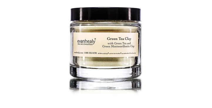 Front view of Green Tea Clay jar showcasing the product label and black lid in a glass jar on white background