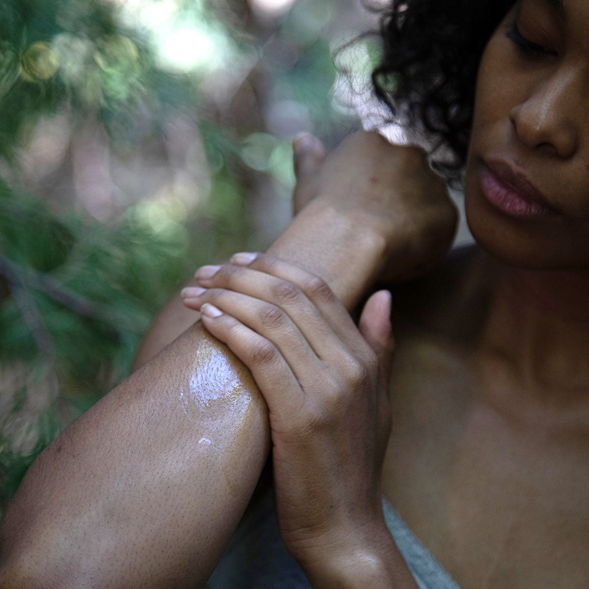 person rubbing evanhealy body butter moisturizer to forearm