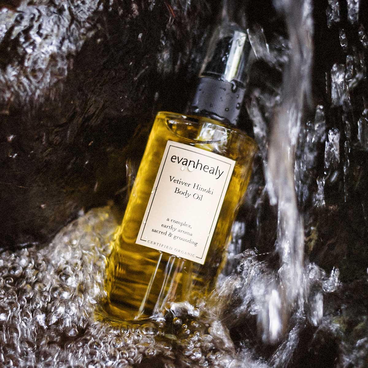 evanhealy vetiver hinoki body oil in waterfall on rocks