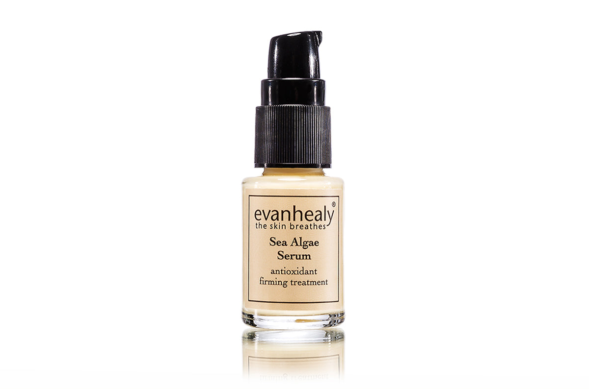 Front view of Sea Algae Serum bottle with black pump and label reading antioxidant firming treatment on white background