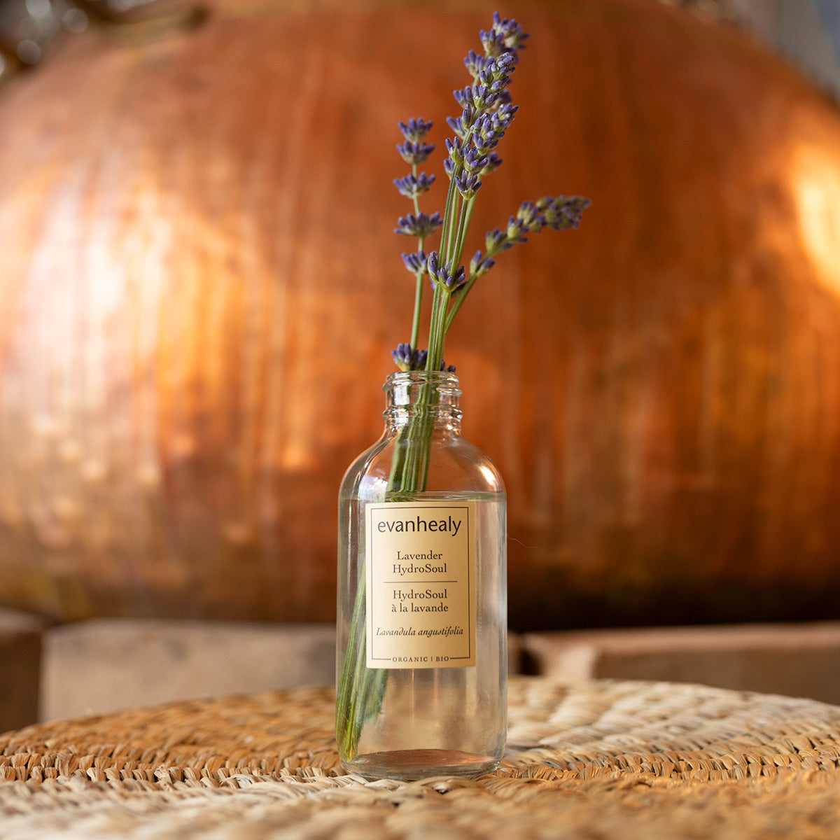 Front view of Lavender HydroSoul bottle showcasing lavender stems with a warm wooden background