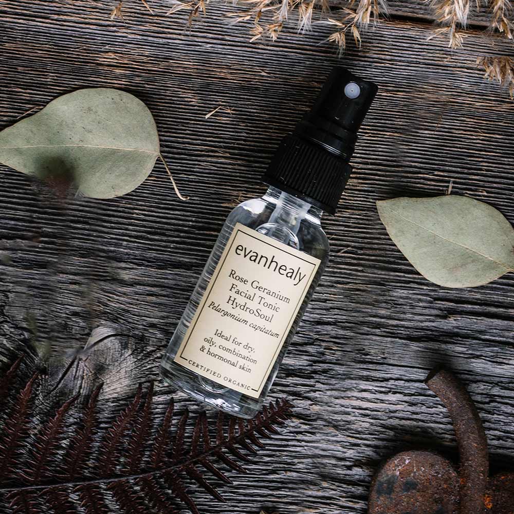 travel size rose geranium hydrosol facial toner on wooden surface