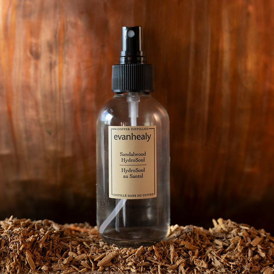 Front view of Sandalwood HydroSoul spray bottle showcasing copper-distilled labeling on wood chips