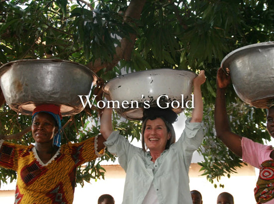 Women carrying metal bowls on their heads under a tree with overlaid headline Women’s Gold