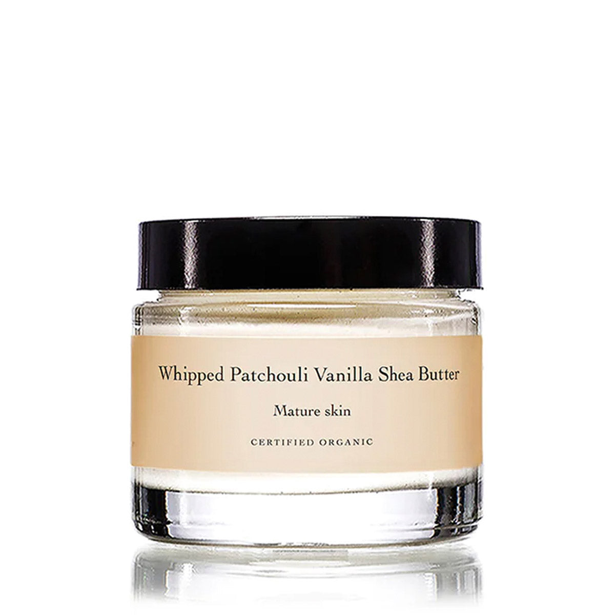 Front view of Whipped Patchouli Vanilla Shea Butter moisturizer in a clear jar with black lid on white background