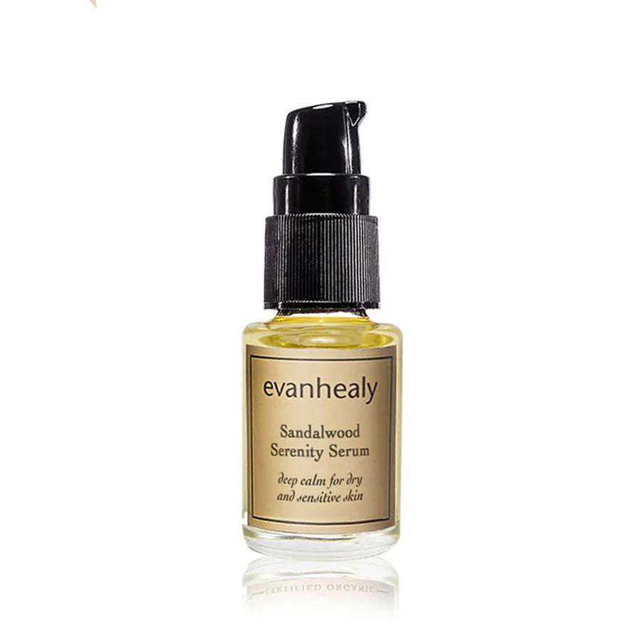 Front view of Sandalwood Serenity Serum showcasing an amber glass bottle with black pump on a white background