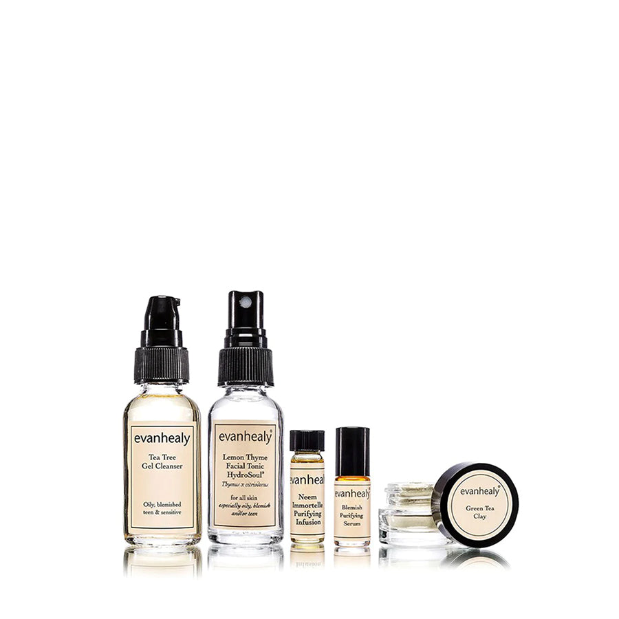Front view of Purifying Ritual blemish face care kit showcasing skincare bottles, a tube, and a jar on a white background
