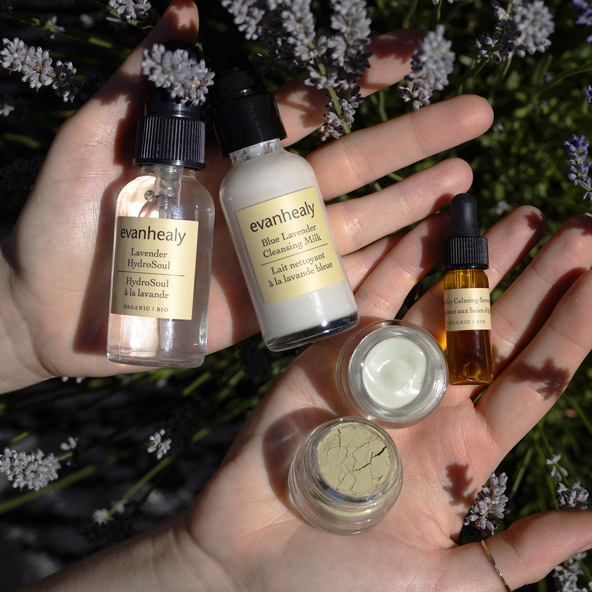 Close-up of evanhealy Calming Starter skincare set showcasing bottles and jars against a floral background