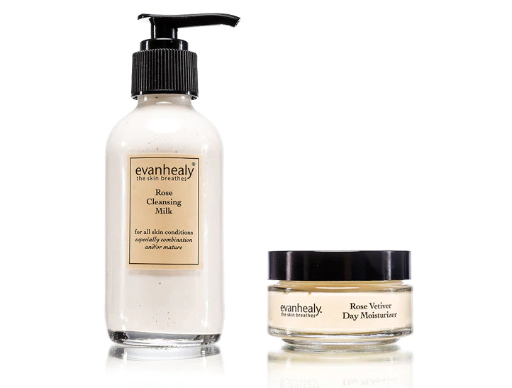 Front view of Rose Cleansing Milk pump bottle and Rose Vetiver Day Moisturizer jar on white background, labels visible