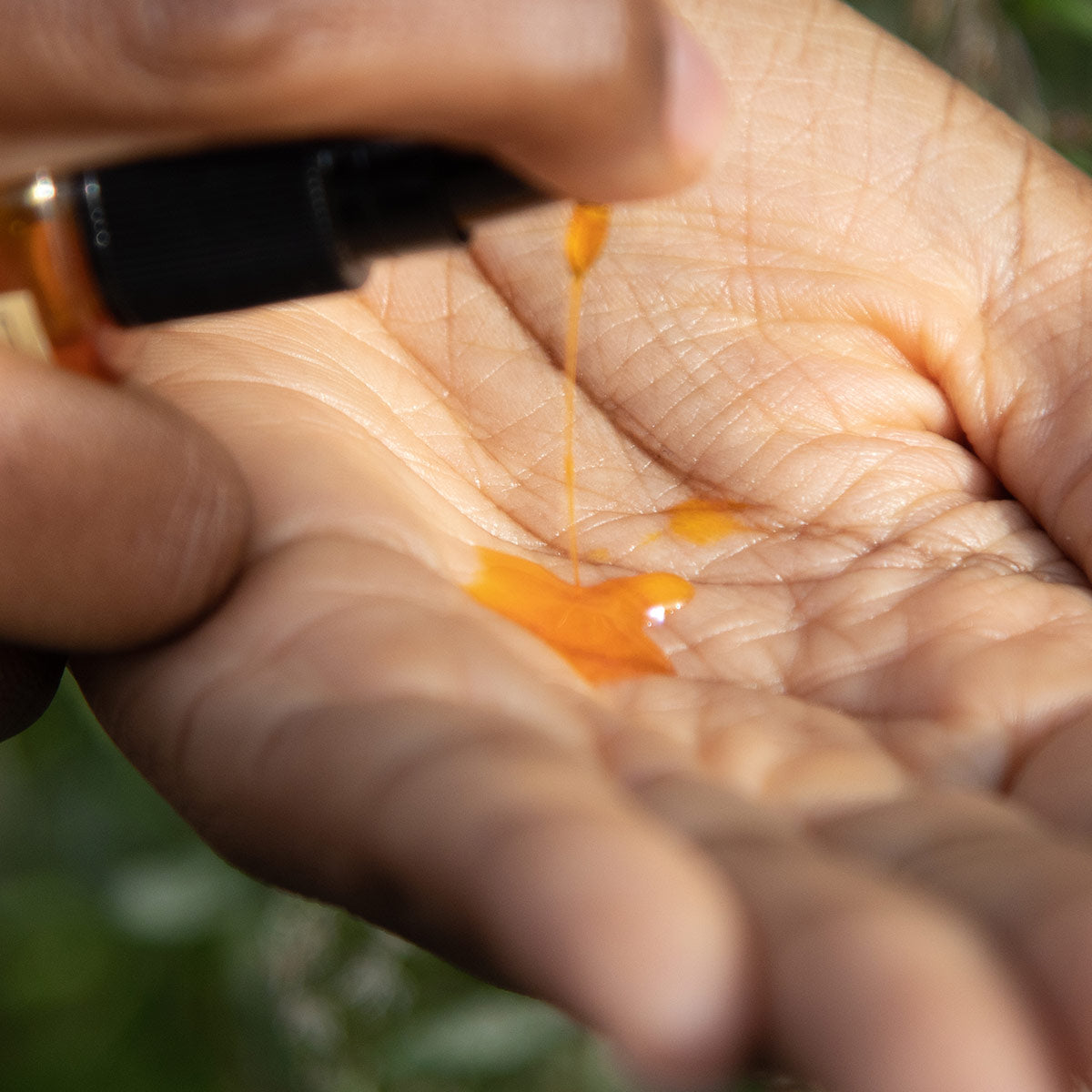 pomegranate sea buckthorn oil serum texture in palm of hand