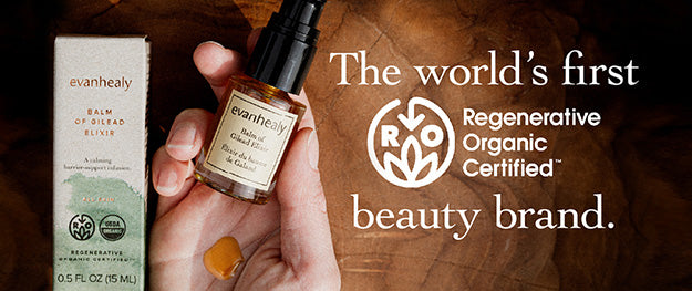 Evanhealy bottle beside its box on a wood surface with headline The world’s first Regenerative Organic Certified beauty brand