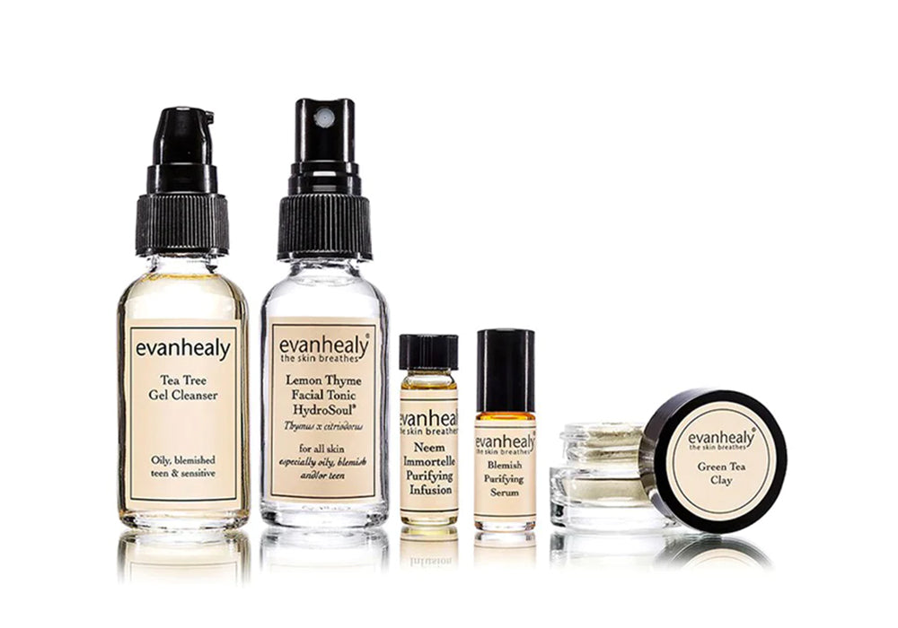 Front view of Purifying Starter set showing five glass travel-size bottles and a small green-tea clay jar on white background