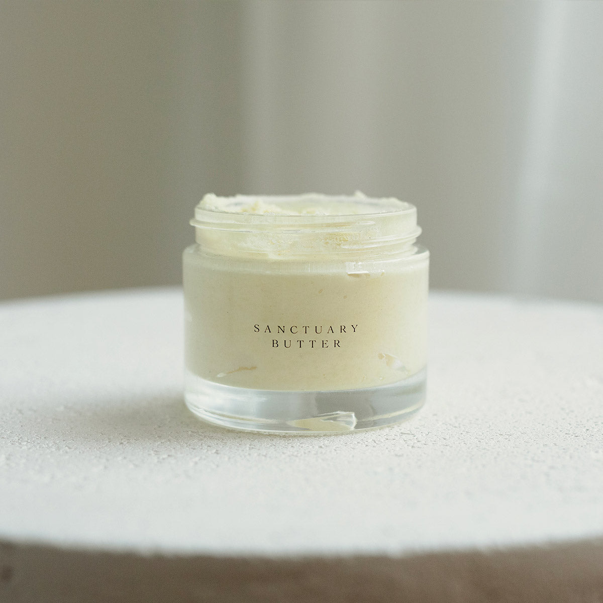 whipped shea butter with frankincense from boswellia tree on table with lid removed