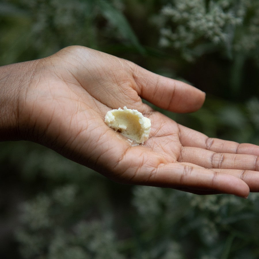 whipped patchouli vanilla shea butter clump in palm of hand